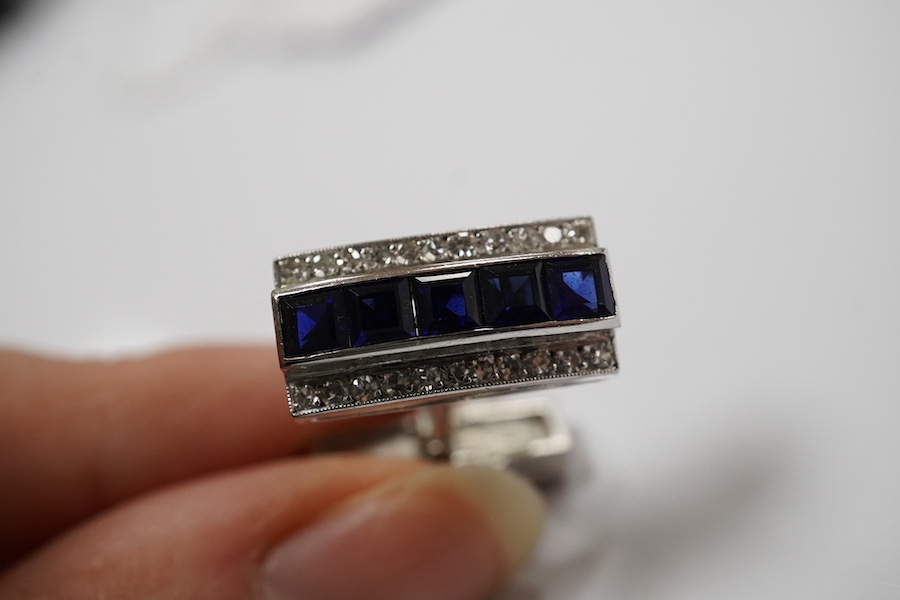 A pair of white metal, synthetic sapphire and diamond three row line cuff links, of curved rectangular form, 18mm, gross weight 16.6 grams. Condition - fair to good